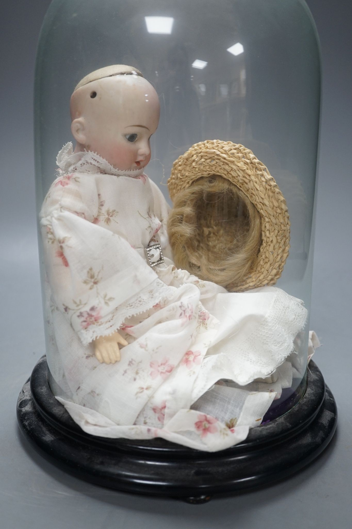 An Armand Marseille bisque doll, mould 1894, under glass dome 29cm